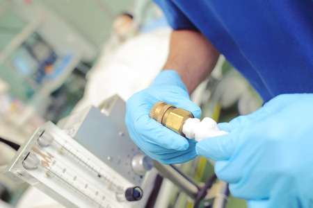 Medical worker in the hospital controls gas passing.の写真素材