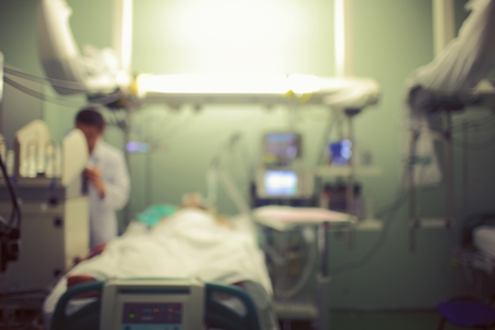 Unfocused background of ICU with doctor and patient.の写真素材