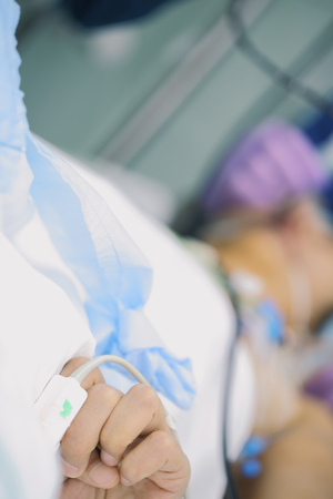 Patient squeezes his hand from pain during the medical procedure.の写真素材
