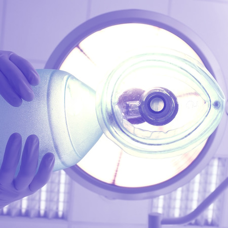 Gloved hand with ventilator bag in the surgery room.の写真素材