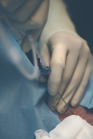 Doctor draws a blood sample of patient.