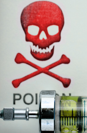 Drug syringe on the background of scull-and-crossbones.の写真素材