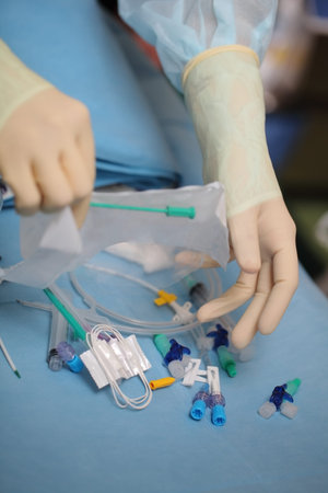 Medical worker opened the pack of catheterization tools during preparation to narcosis before...