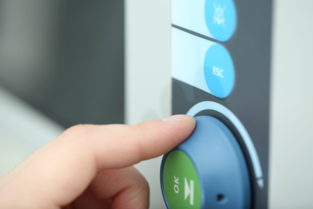 Hand rotating regulation knob, concept of technical support worker adjusting new advanced equipment.の写真素材