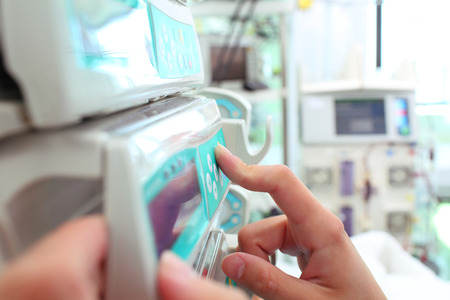 Female lab technician adjusts the digital equipment.の写真素材