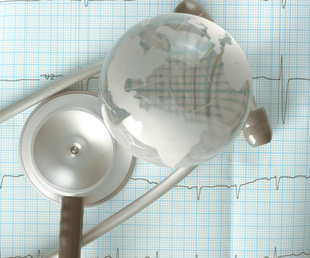 Glass globe and stethoscope over the ECG trace, concept of diagnosis of cardiac diseases.