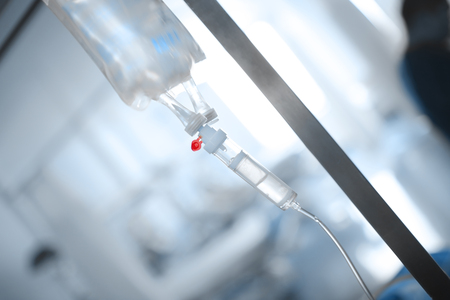 Drip bag on the metal stand in the hospital room.の写真素材