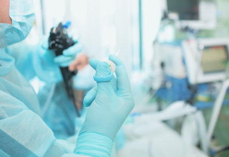 Medical worker during endoscopic manipulation in the patient ward.
