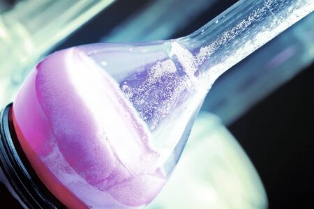 Glass laboratory dish with the liquid content close-up.の写真素材