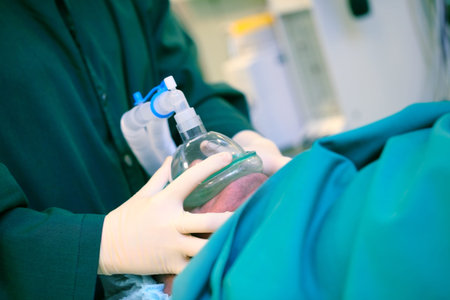 Doctor presses the artificial respiratory mask to the patient's face, concept of an...
