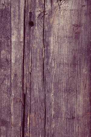 Rough surface of wooden plank with nail hole and cracks, textured background.の写真素材