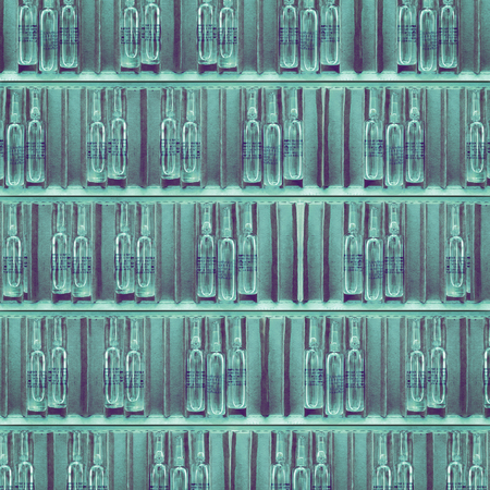 Rows of open cardboard packs of drug vials.の写真素材