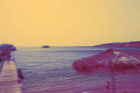 Blurred seascape in yellow tones, unfocused background.の写真素材