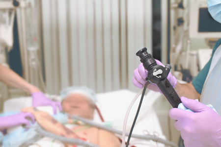 Medical workers team prepares to bronchoscopic procedure to the citical patient in the ICU.の写真素材