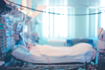 Bed in a medical psychiatric room with a mix of light shadow color Abstract blurred defocused medical news backgroundの写真素材