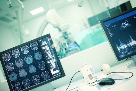 MRI scan on the computer display against the patient during examination in the room behind the...