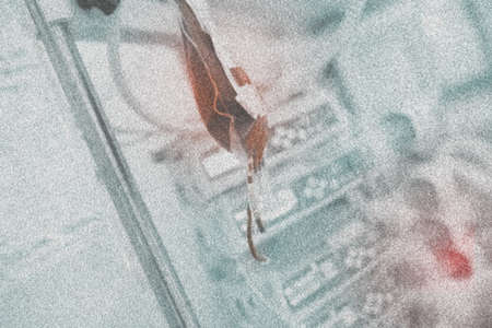 Blood transfusion bag on the pole, grained background.の写真素材