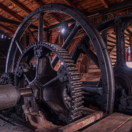 Old flywheels inside the old wooden factory