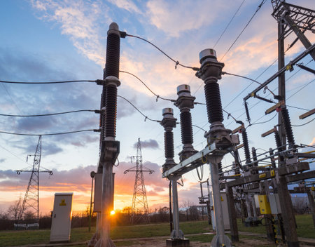 High voltage power substation in the sunset sky