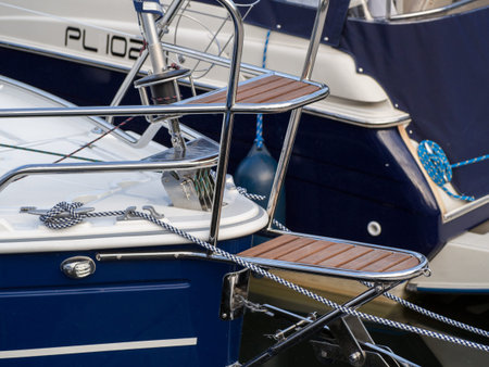 Shiny steel rails on the blue yacht bow.