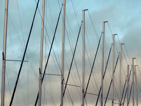 Row of yacht mainsails and lines. Cloudy sky.の写真素材