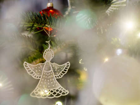 White lacy angel ornament. Christmas card. Bokeh, bluredの写真素材
