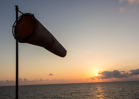 windsock and sunset over sea