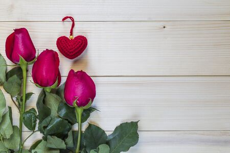 Beautiful red roses and red heart on wooden background for valentine day.の写真素材