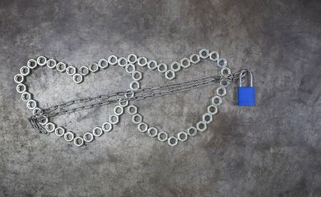 Two nut heart with blue key on the metal background. The nut heart is locked  for valentines day.の写真素材