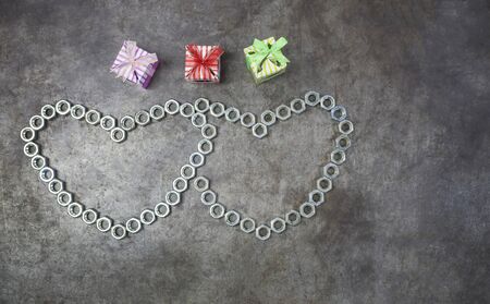 Two nut heart and three gift on the metal background for valentines day.の写真素材