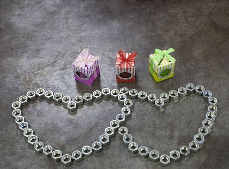 Two nut heart and three gift on the metal background for valentines day.の写真素材