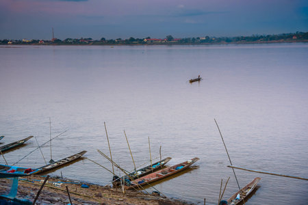 local longtail boats at Kong river with blue and orange sky before sunsetの写真素材