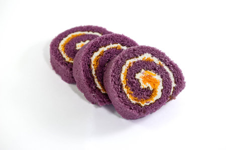 slice of swiss roll isolated on white backgroundの写真素材