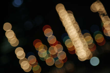 image of blurred bokeh background with warm colorful lights. Abstract circular bokeh background of festival Christmas lightの写真素材