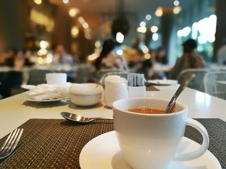 a hot milk coffee cup of coffee in a restaurantの写真素材