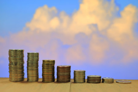 Twilight blue and red cloud sky. Coin pile, Thai baht stacking column.  Business, money, saving and...