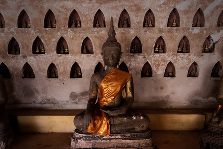 the righteous path. black color buddha meditation for peace and enlightment, sculpture art in laos temple.の写真素材