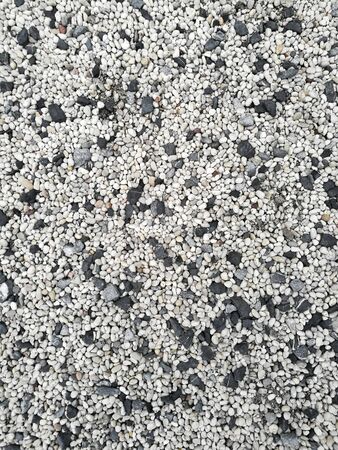 Gravel floor. loose material covering dirt ground. mixed color, white grey and black, stone pebble ground cover. landscape flooring material design element.の写真素材