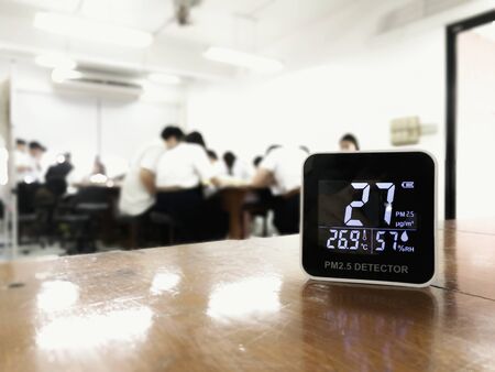 measuring indoor air quality. PM 2.5 (particulate matter) small dust particle pollution detector found higher than acceptable standard of dust in a classroom with students. harmful indoor environmentの写真素材