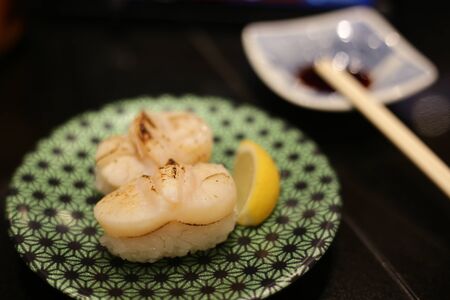 Sushi in a Japanese cuisine restaurant. burnt scallops on rice ball nigiri.の写真素材