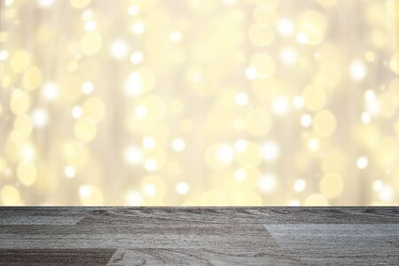 empty table wood plank and golden yellow bokeh glittering background,  luxury gold light shining for product montage display.の写真素材