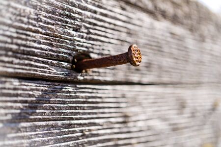 wooden board with a rusty nailの写真素材