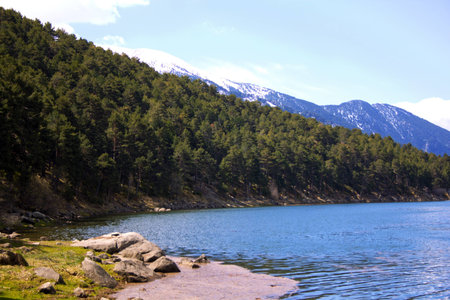 Cold waters of the reservoir with snow on the mountains behindの写真素材
