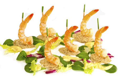 Crisp bread shapes and wooden sticks capped with onion stalks hold the shrimps upright  Lettuce, corn salad and red cabbage make up the sea の写真素材