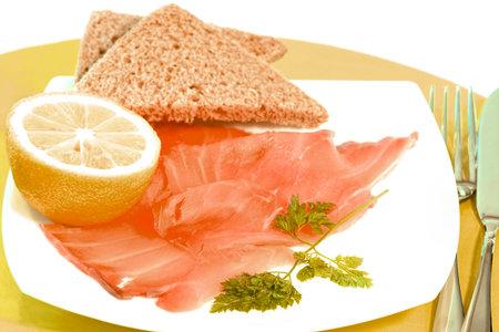 Tasty snack of smoked salmon with brown bread cut in triangles の写真素材