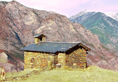 Patchwork Stone Built Church in the Winter Afternoon Surrounded by Snow-Capped Mountains の写真素材