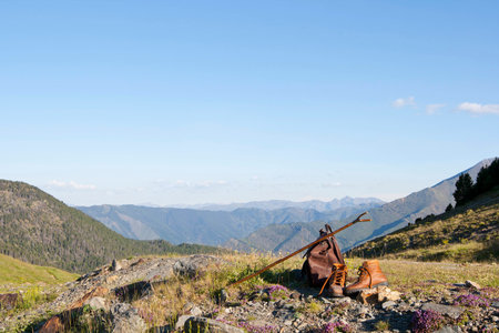 View of Blue Skies Above a Mountain View with Hiking Gear in the Foregroundの写真素材