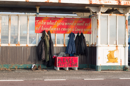 Seaside shelter on Hove promenade, with donated clothes free for homeless people to take.の写真素材