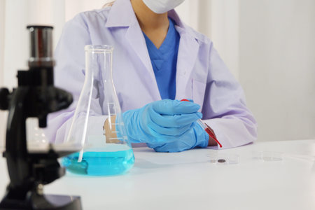 Female doctor working in laboratory for testing on  vaccine for pandermic covid19.
