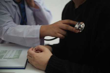 Doctor use stethoscope checking up heart beat of the patient.の写真素材